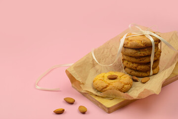 Cookies with almond, homemade almond cookies on a pink background, copy space