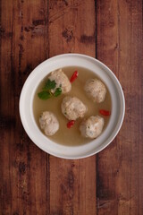 chef handmade fresh seafood meat pork ball dumpling in frozen and hot soup bowl on wood background top view chinese menu