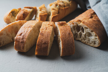 Freshly baked homemade bread with crispy crust on gray background