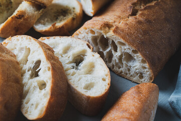Freshly baked homemade bread with crispy crust on gray background