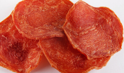A few pieces of meat chips on a white background. Meat chips.