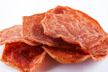 A few pieces of meat chips on a white background. Meat chips.