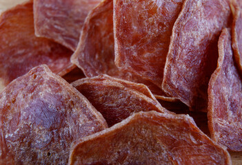 Meat chips. A backdrop of pieces of meat.