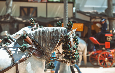 Obraz na płótnie Canvas Traditional artisans ornaments on the head of carriage horses at the fair in Jerez de la Frontera Cadiz