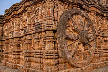 Fototapeta na wymiar Konark Sun Temple is 13th-century temple at Konark in Odisha, India. Dedicated to the Hindu Sun God Surya, it has appearance of a 100 feet high chariot with immense wheels & horses carved from stone