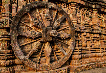 Fototapeta na wymiar Konark Sun Temple is 13th-century temple at Konark in Odisha, India. Dedicated to the Hindu Sun God Surya, it has appearance of a 100 feet high chariot with immense wheels & horses carved from stone