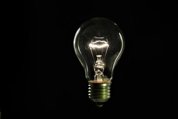 tungsten light bulb on black background