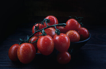 Ripe juicy tomatoes in a ceramic dish.