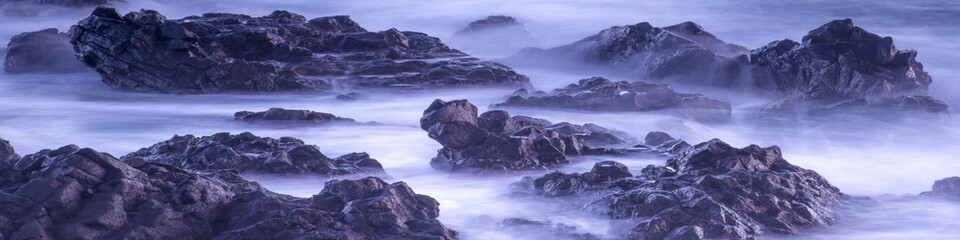 Water with rock nature photo with long exposure fog effect abstract color ocean background 
