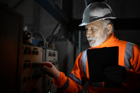 Industrial Engineer Electrician Checking Malfunction Of Voltage And Electric Installation Of Electrical Cabinets In Production Factory.