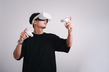 Surprised teen male student use vr glasses and looks at empty space with gray background. Virtual...