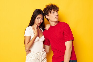 portrait of a man and a woman together posing emotions close-up yellow background unaltered