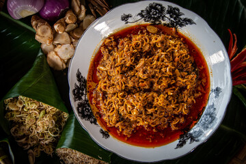 Rendang serai or we call it rendang lemongrass plating on white plate for eid mubarak with a spicy seasoning. 