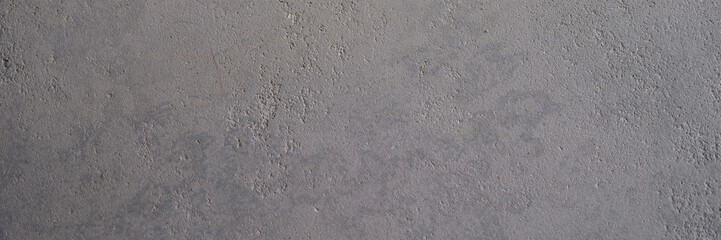 Gray concrete uneven wall with stains closeup