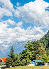 Blue Sky with full of White Clouds, and green trees, and the mountain is full of greeneries, a magical view of north Pakistan, Shogran National Park. 