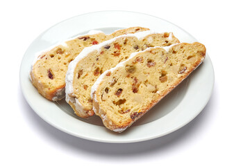 Slices of Traditional Christmas stollen cake with marzipan and dried fruit isolated on white ceramic palte
