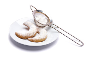 Traditional German or Austrian Vanillekipferl vanilla kipferl cookies on a plate isolated on white background