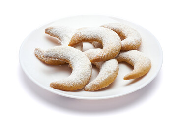 Traditional German or Austrian Vanillekipferl vanilla kipferl cookies on a plate isolated on white background