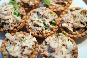 Tartlets with cod liver and herbs
