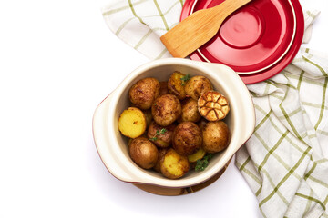 Baked potato in a clay pot isolated on white background