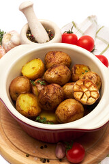 Baked potato in a clay pot isolated on white background