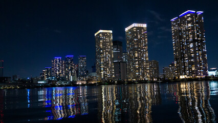 Night view of a high-rise condominium along an urban river_08