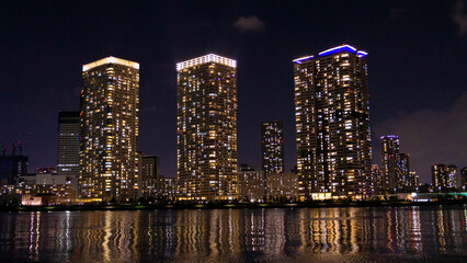 Fototapeta na wymiar Night view of a high-rise condominium along an urban river_10