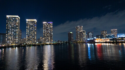 Fototapeta na wymiar Night view of a high-rise condominium along an urban river_12