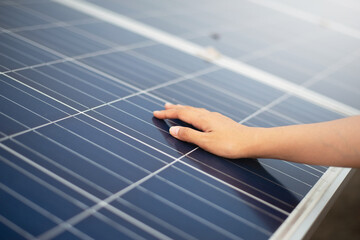 Close up of engineer hand is checking an operation of photovoltaic solar panels. Renewable energy...