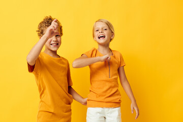 Boy and girl casual wear games fun together posing on colored background