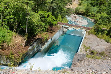 Vivid blue waterway river at Panguna copper and gold mine in Bougainville, Papua New Guinea