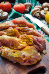 raw chicken thighs with spices and mushrooms
