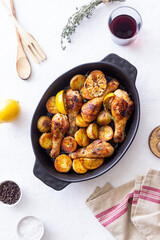 Baked chicken legs with potatoes and lemon. Recipe.