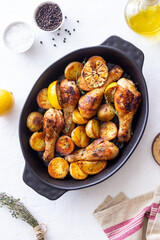 Baked chicken legs with potatoes and lemon. Recipe.