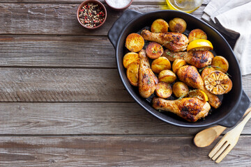 Baked chicken legs with potatoes and lemon. Recipe.