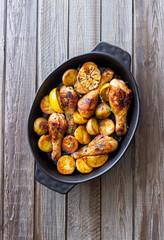 Baked chicken legs with potatoes and lemon. Recipe.