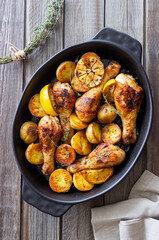 Baked chicken legs with potatoes and lemon. Recipe.