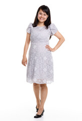 Portrait studio cutout isolated full body shot of Asian young happy trendy female model in beautiful gray lace dress standing posing holding hand on waist smiling look at camera on white background