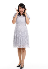 Portrait studio cutout isolated full body shot of Asian young happy trendy female model in beautiful gray lace dress standing posing holding hand on waist smiling look at camera on white background