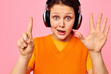 beautiful woman headphones music fashion posing pink background unaltered