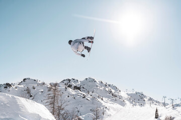 snowboarder jumping in the air on sky