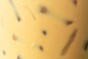 macro iced coffee,Close-up of Cold latte drink with ice cubes,Iced coffee in takeaway cup