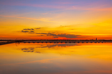 Fototapeta premium Sunset salt farming (Naklua) in the coastal, Phetchaburi provinces of Thailand, Landscape