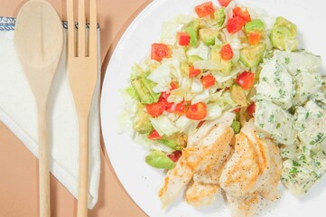 Stewed chiken with boiled potato on the plate.