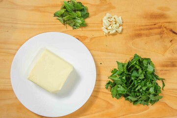 Herb butter isolated on wooden background