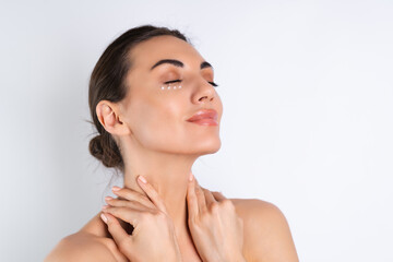 Close-up beauty portrait of a topless woman with perfect skin and natural make-up, with anti-aging cream dots to moisturize and firm the skin under the eyes.