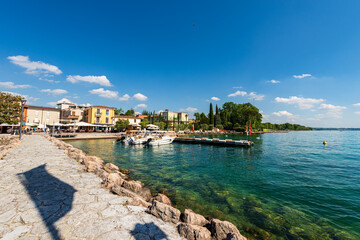 Small port of the village of Cisano with motor boats moored. Tourist resort on the coast of Lake...