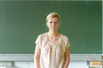 Thoughtful school teacher frowning in concentration