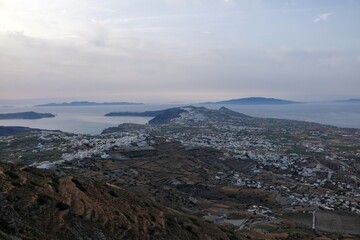 Panoramic view of the island of Santorini while the sun is slowly setting