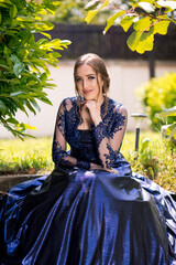 Beautiful girl in glamorous ultramarine dress. Ready for her prom night.